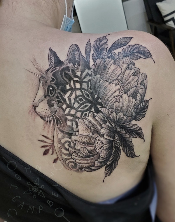 Cat Mandala with peony flowers tattoo in black and grey with dotwork. Book a custom tattoo with John at Sacred Mandala Studio - Durham, NC.